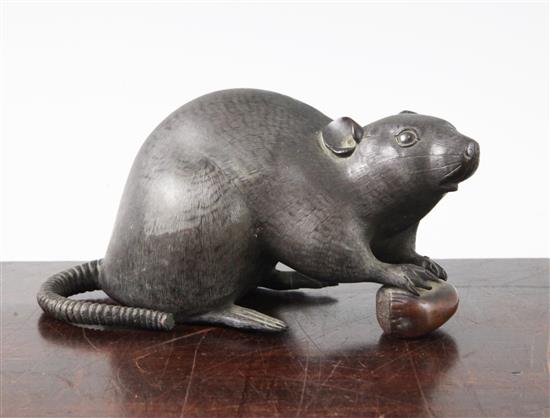 A Japanese bronze model of a rat holding a nut, late 19th century, length 17cm, loss to tail